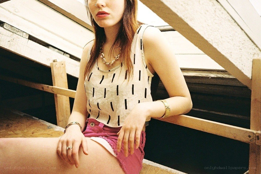 woman in patterned top sitting