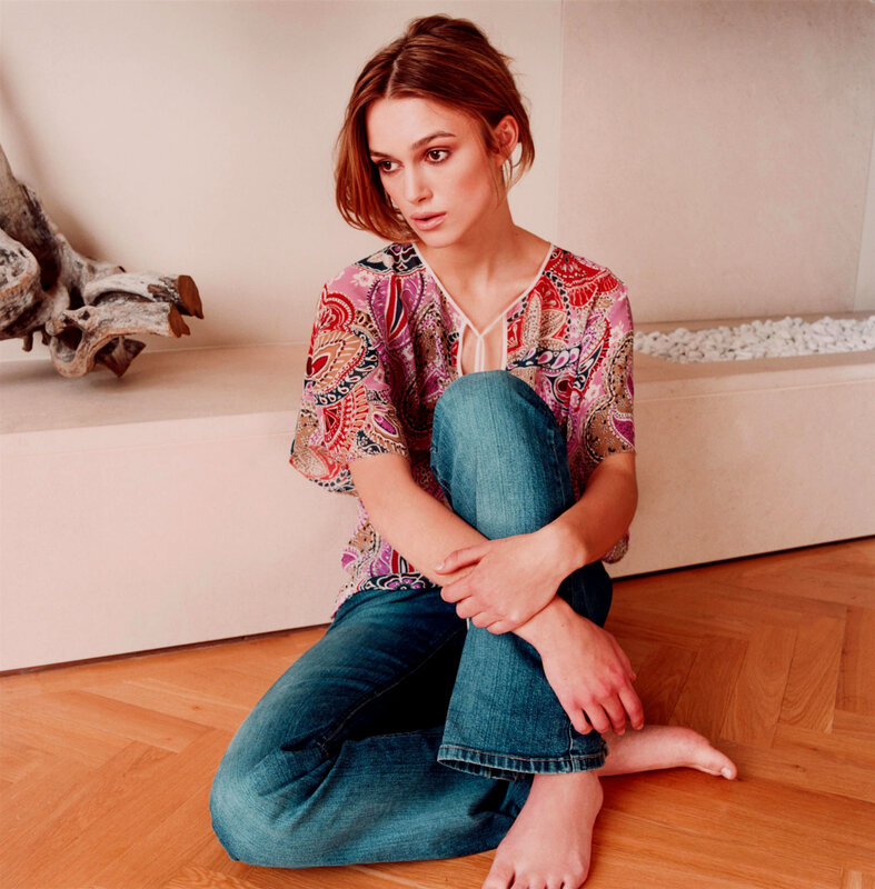 woman in patterned top sitting on floor