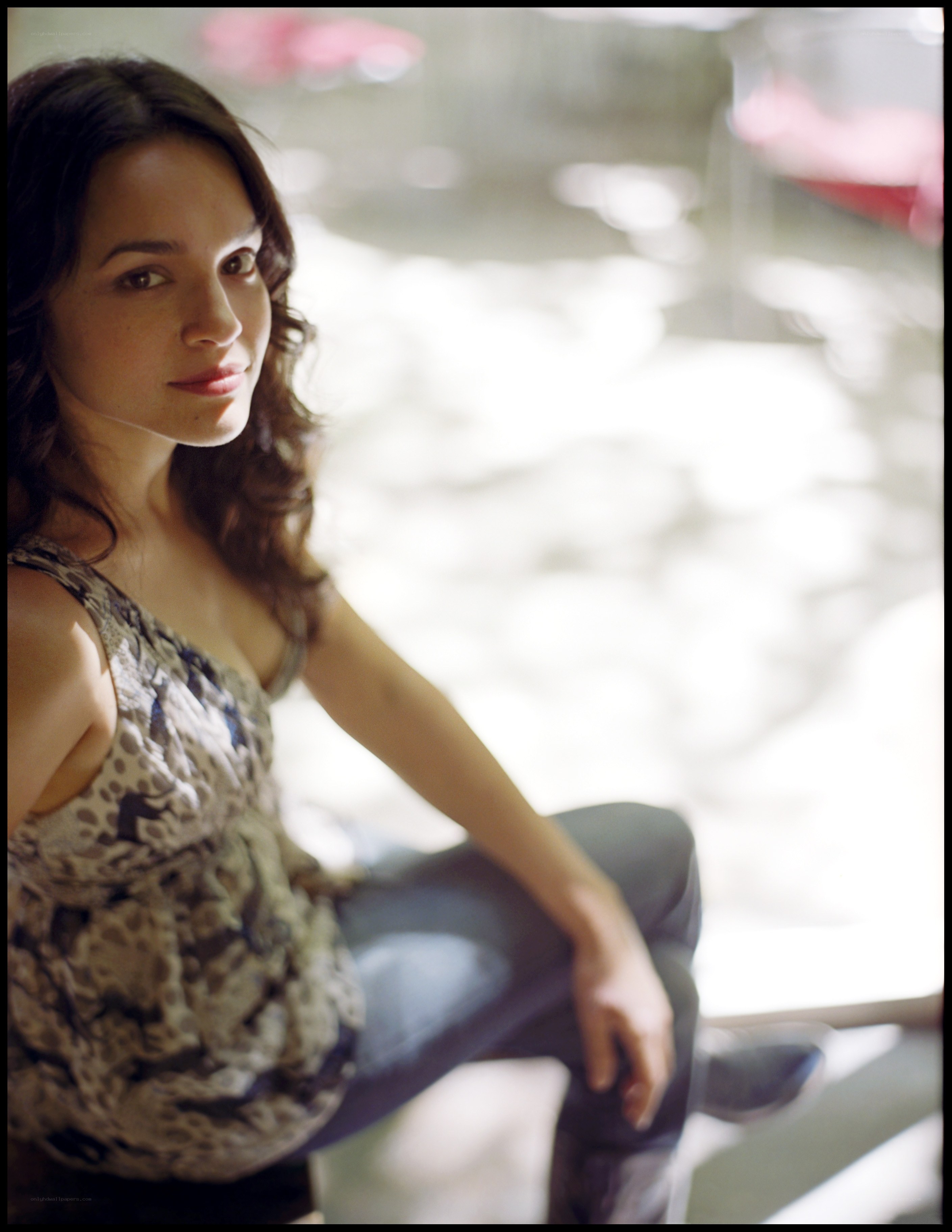 woman in patterned top sitting