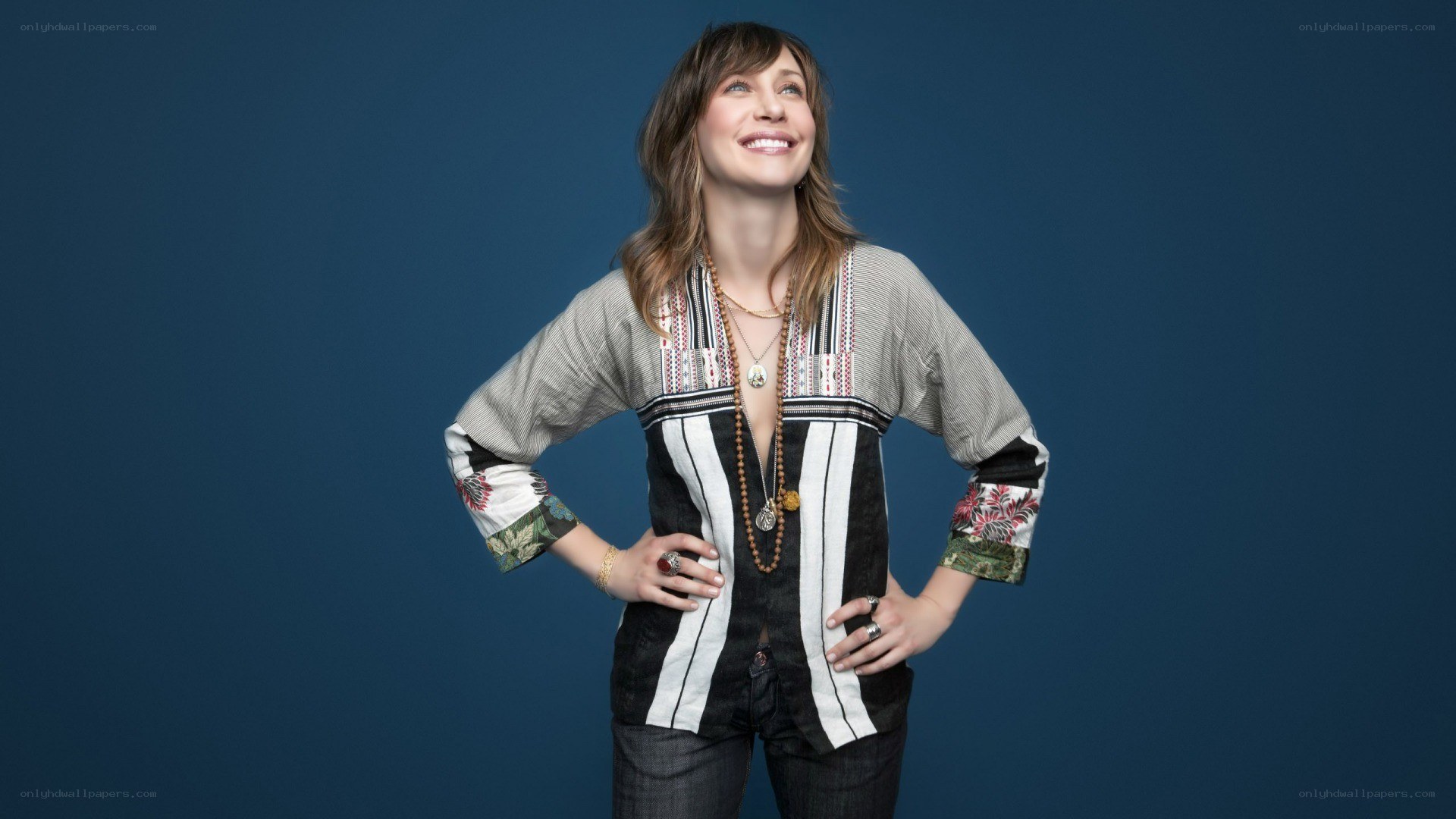 woman in patterned top smiling