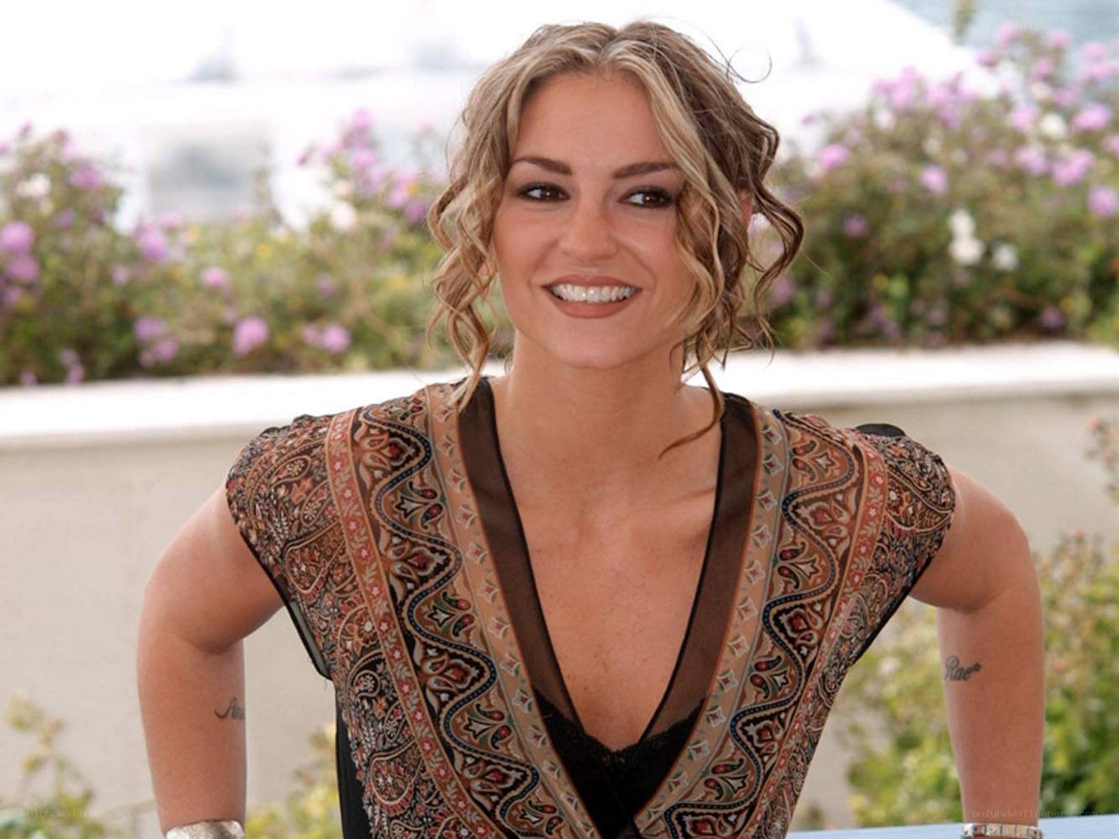 woman in patterned top smiling