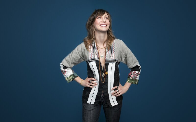woman in patterned top smiling
