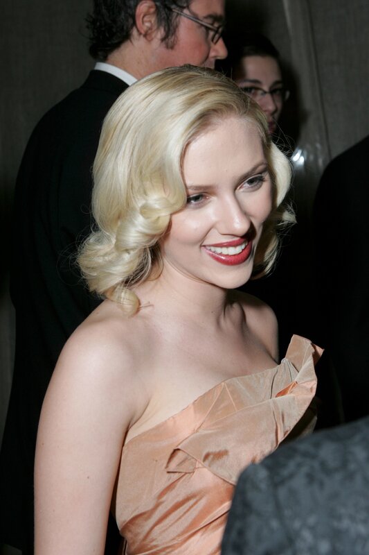 woman in peach dress smiling
