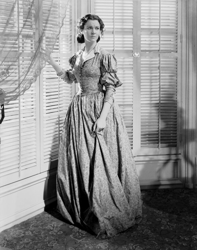 woman in period dress by window