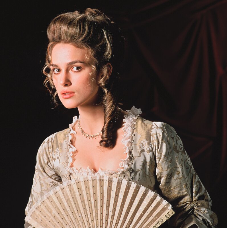 woman in period dress holding fan