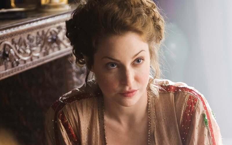 woman in period dress looking at camera
