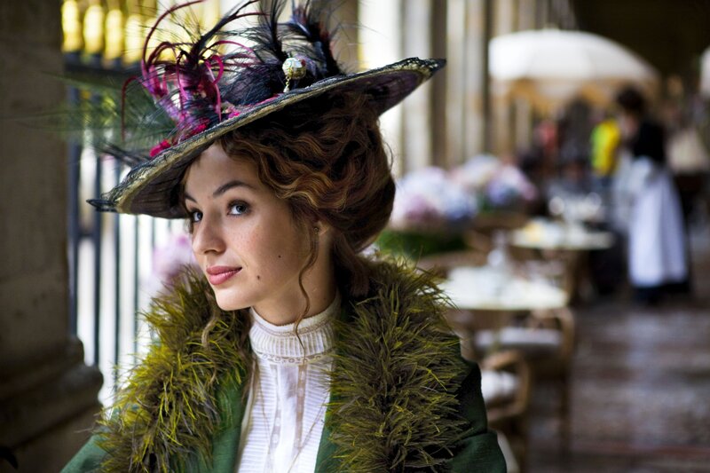 woman in period hat and coat