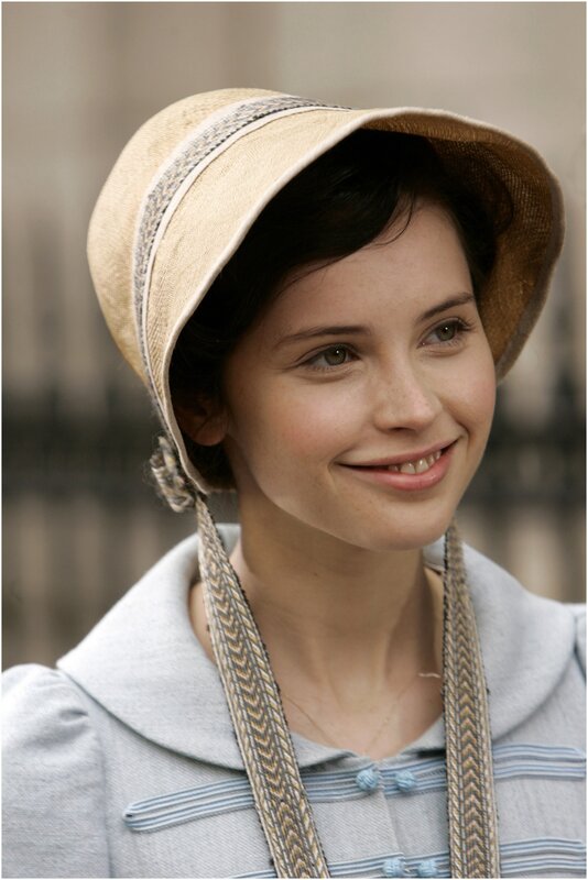 woman in period hat smiling