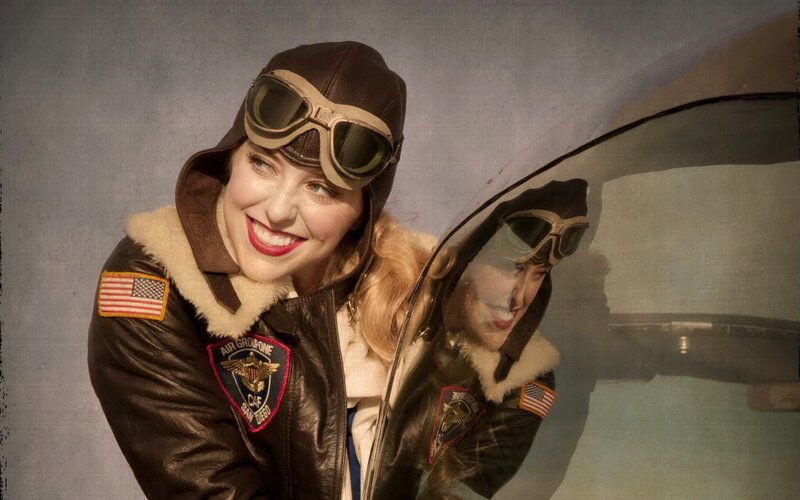 woman in pilot gear smiling