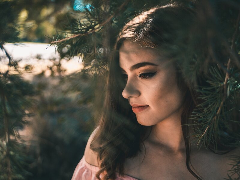 Woman in Pine Branches