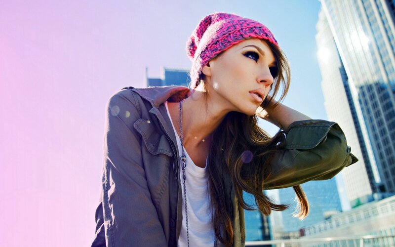 woman in pink beanie on city street
