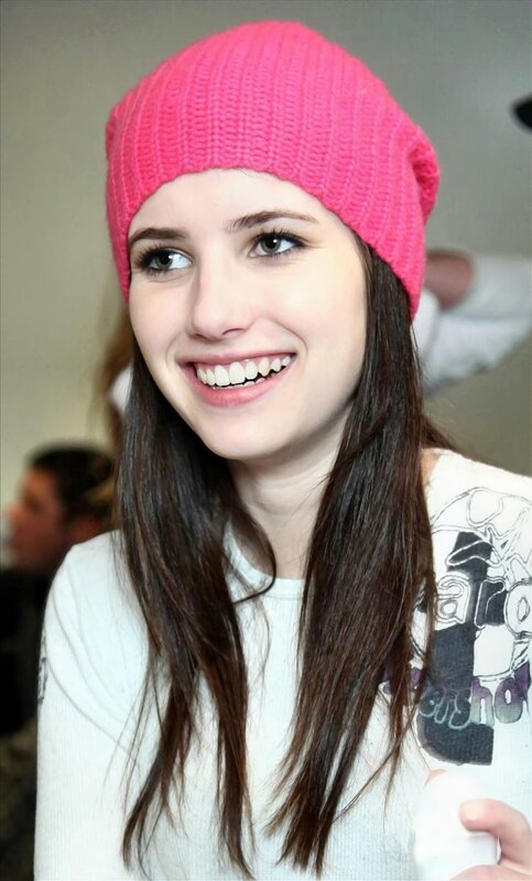 woman in pink beanie smiling