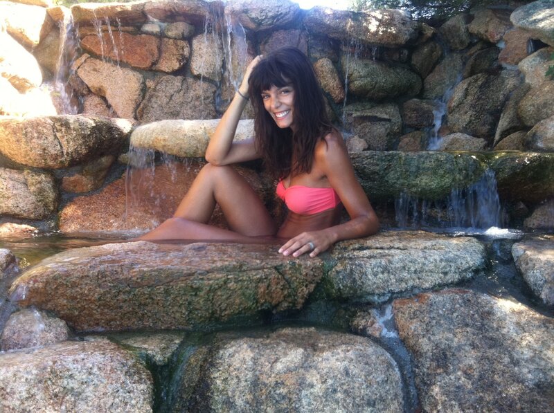 Woman in pink bikini at waterfall