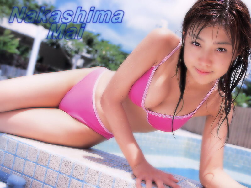 woman in pink bikini by pool