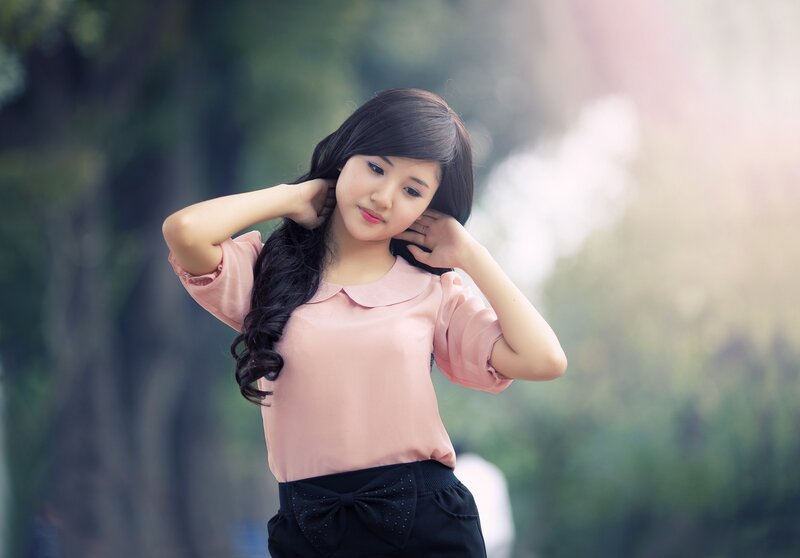 woman in pink blouse outdoors