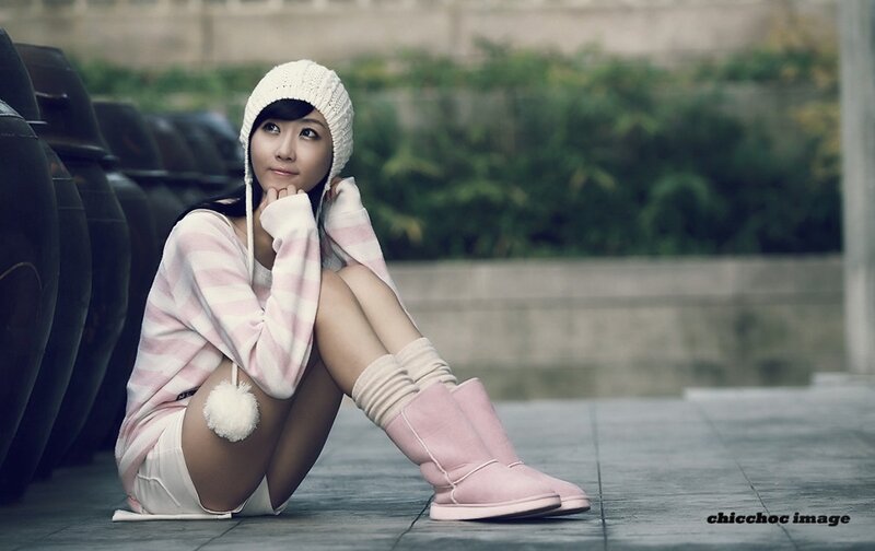 woman in pink boots sitting