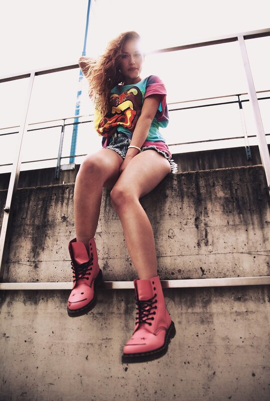 woman in pink boots sitting on steps