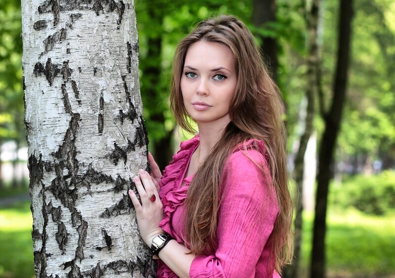 woman in pink by birch tree
