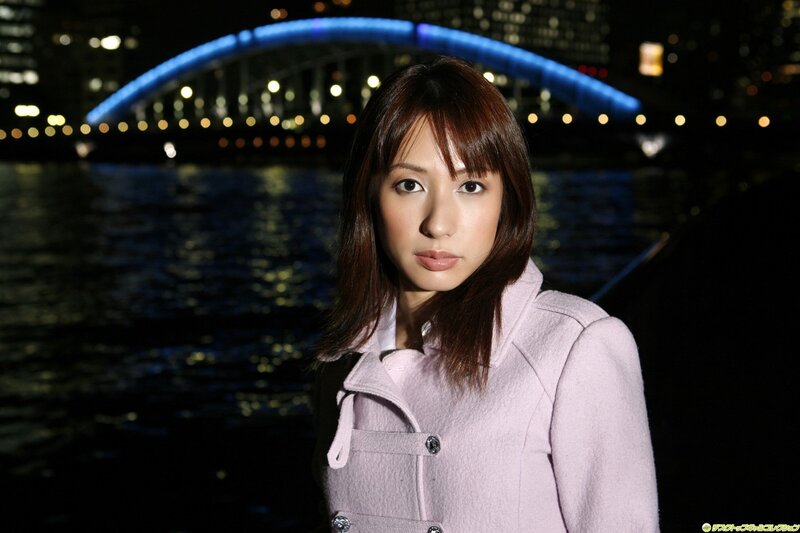 Woman in pink coat at night