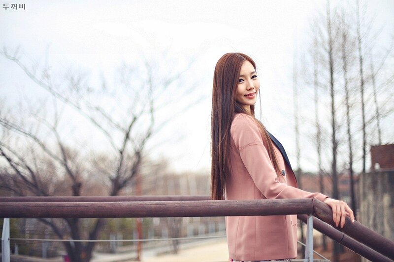 woman in pink coat on bridge