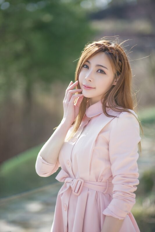 woman in pink coat outdoors