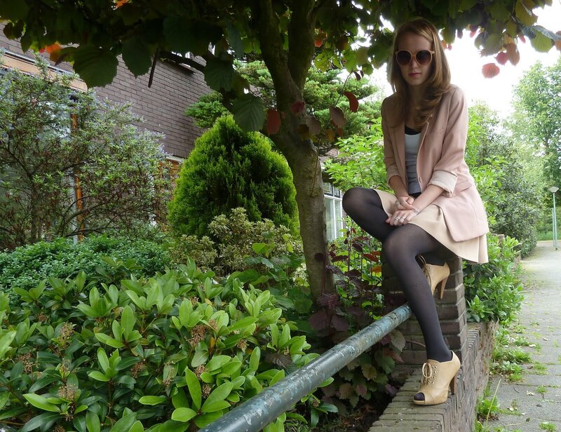 woman in pink coat sitting outdoors