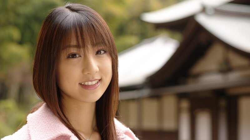 woman in pink coat smiling