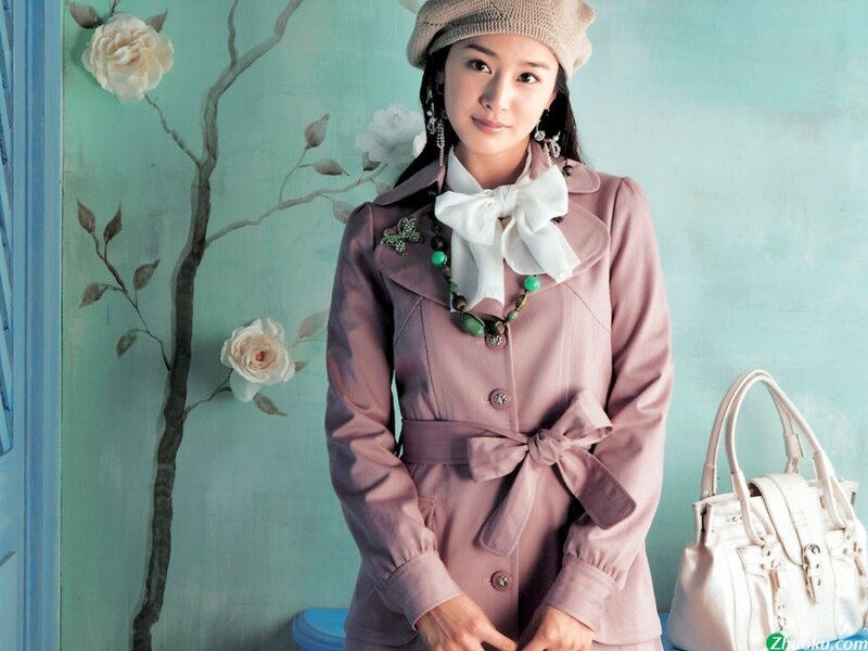 woman in pink coat with white bag