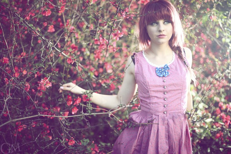 Woman in pink dress among flowers