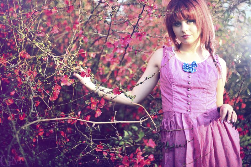 woman in pink dress among flowers