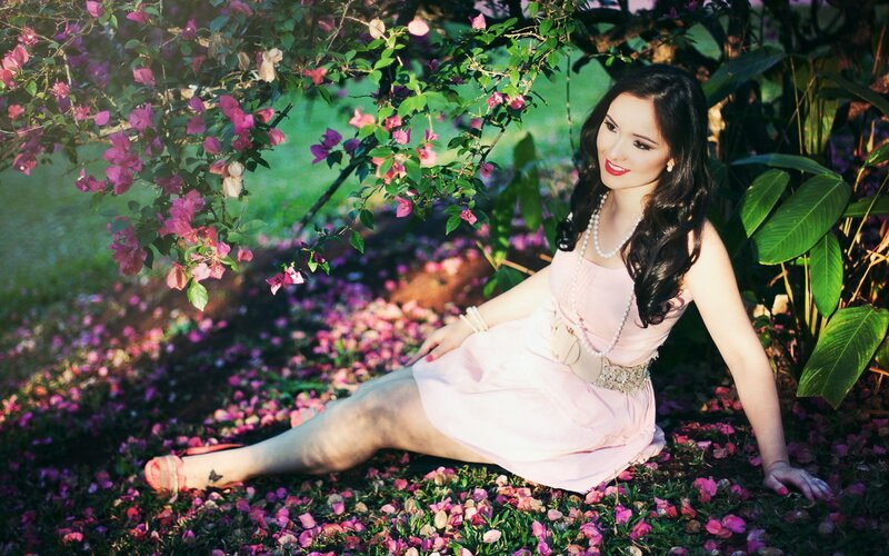 Woman in pink dress among flowers