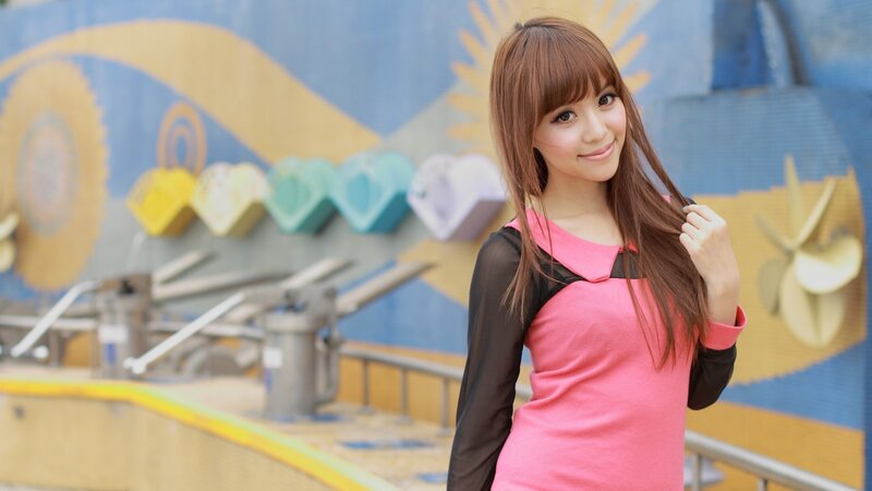 woman in pink dress at amusement park