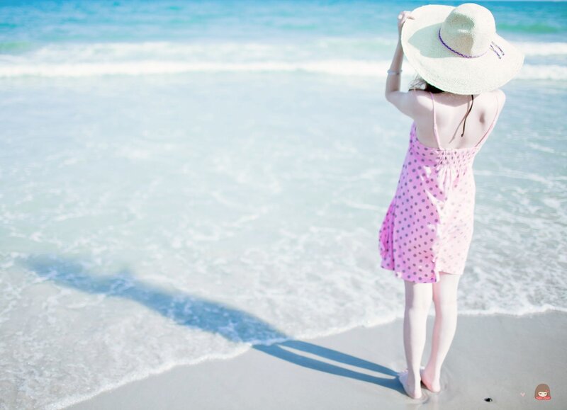 Woman in pink dress at beach