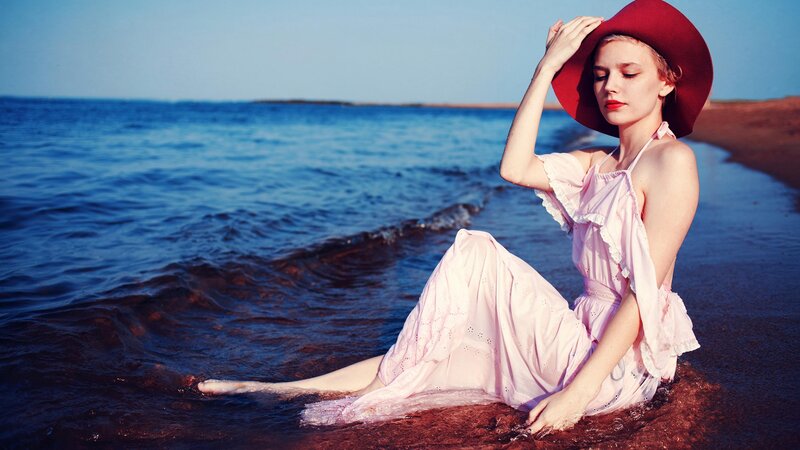 Woman in pink dress at beach