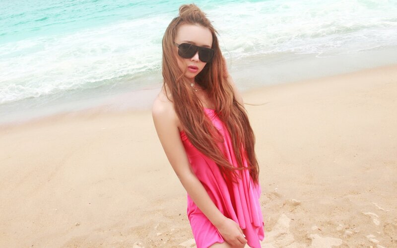 woman in pink dress at beach