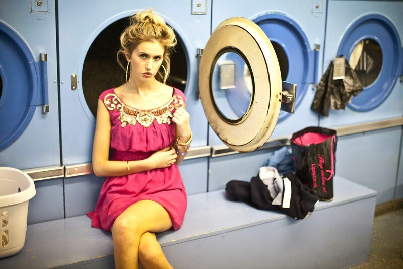 Woman in pink dress at laundromat