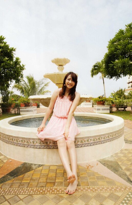 Woman in pink dress by fountain