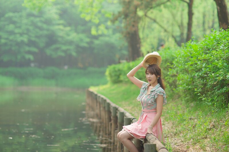 Woman in pink dress by the pond