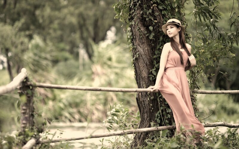 woman in pink dress by tree