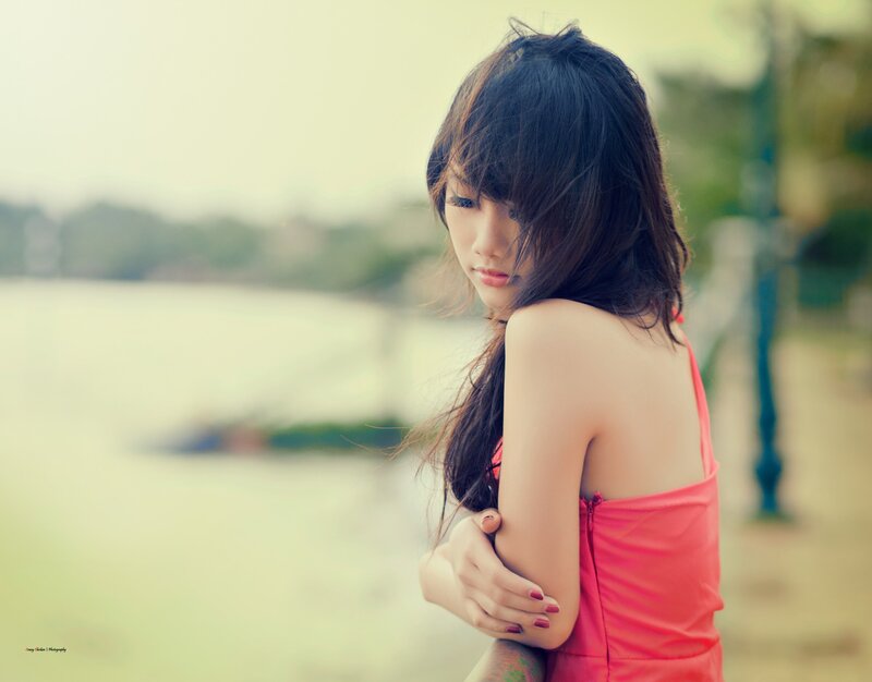 woman in pink dress by water