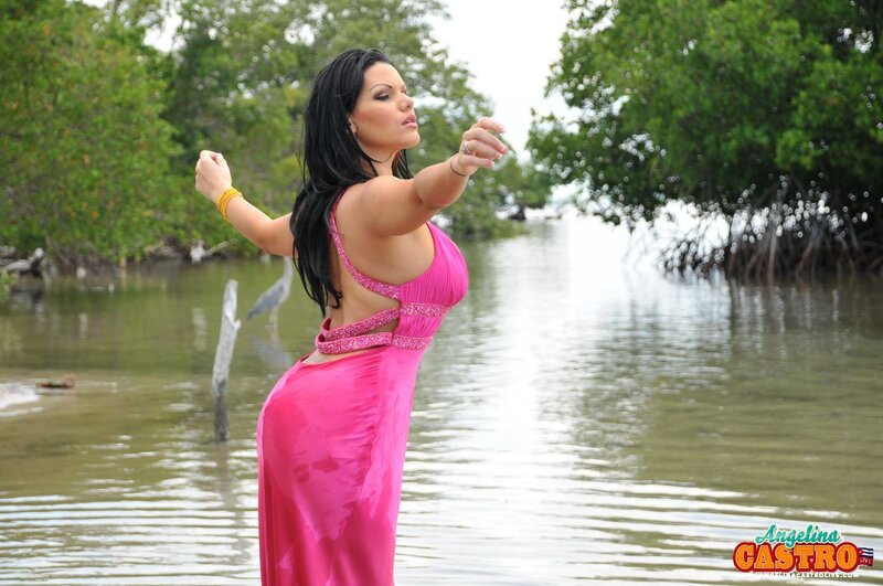 Woman in pink dress by water