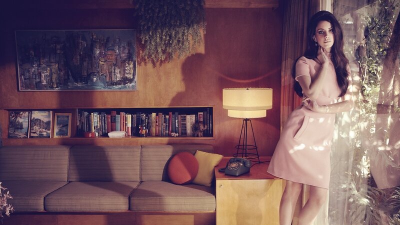 woman in pink dress by window