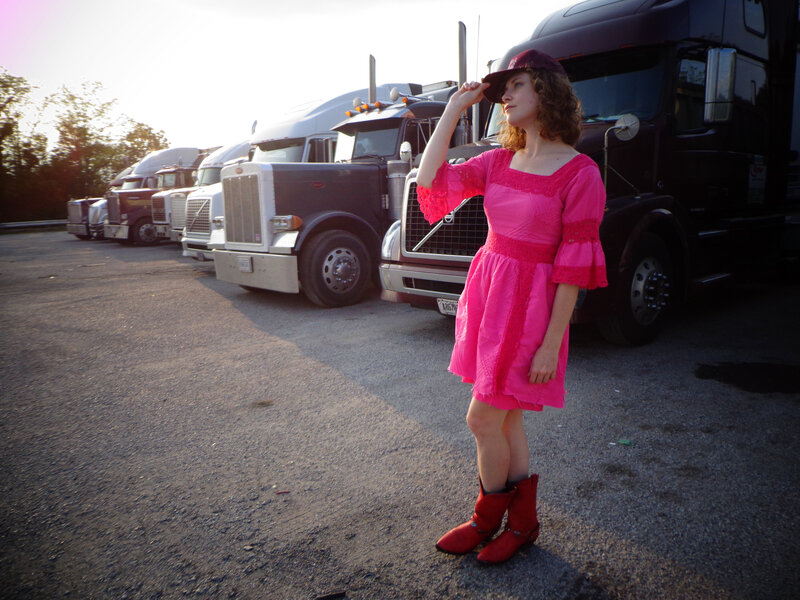 Woman in Pink Dress — Dramatic, Sunset, Photograph, Trucks