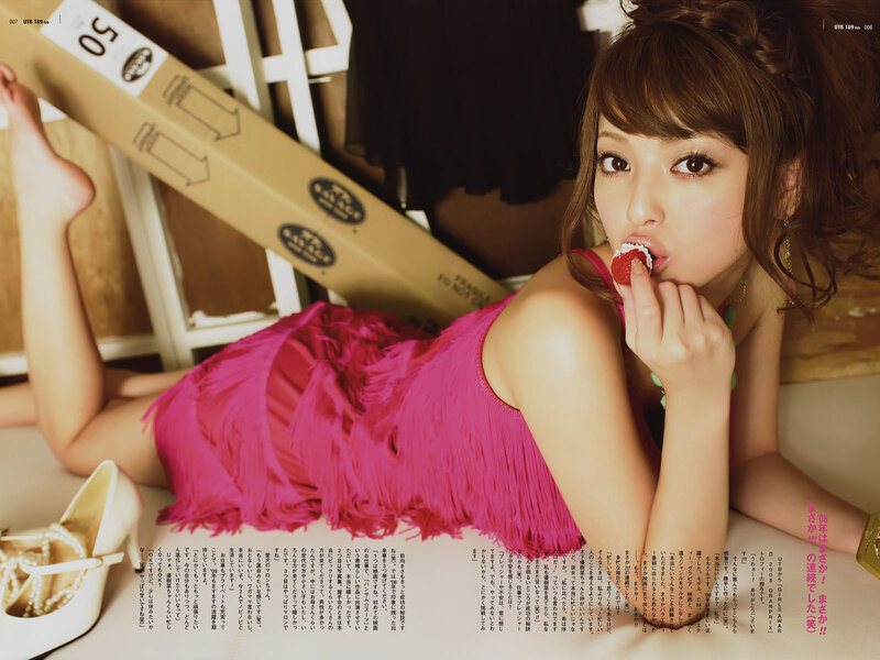 woman in pink dress eating strawberry