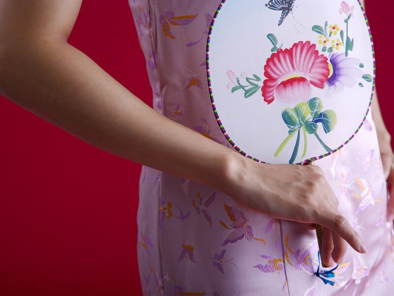 woman in pink dress holding fan