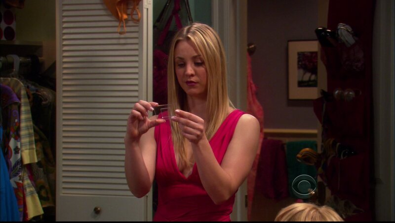 woman in pink dress holding glass
