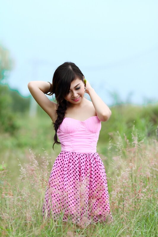 Woman in pink dress in field