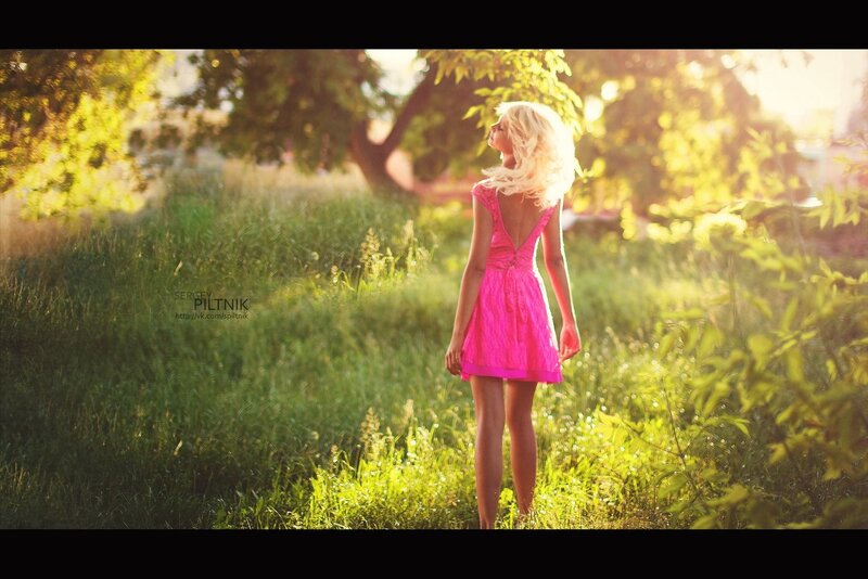 Woman in pink dress in field