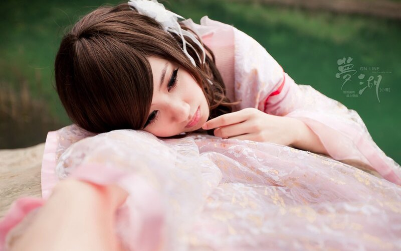woman in pink dress lying down