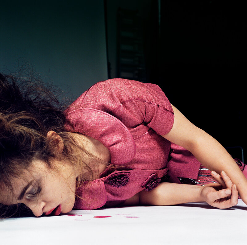 woman in pink dress lying on floor